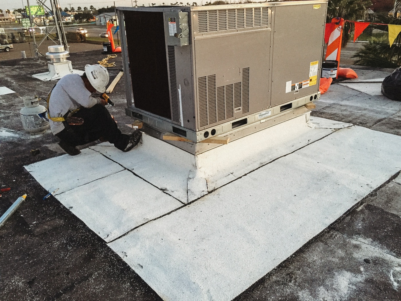 Property Builds crew installing TPO roofing around a commercial rooftop unit