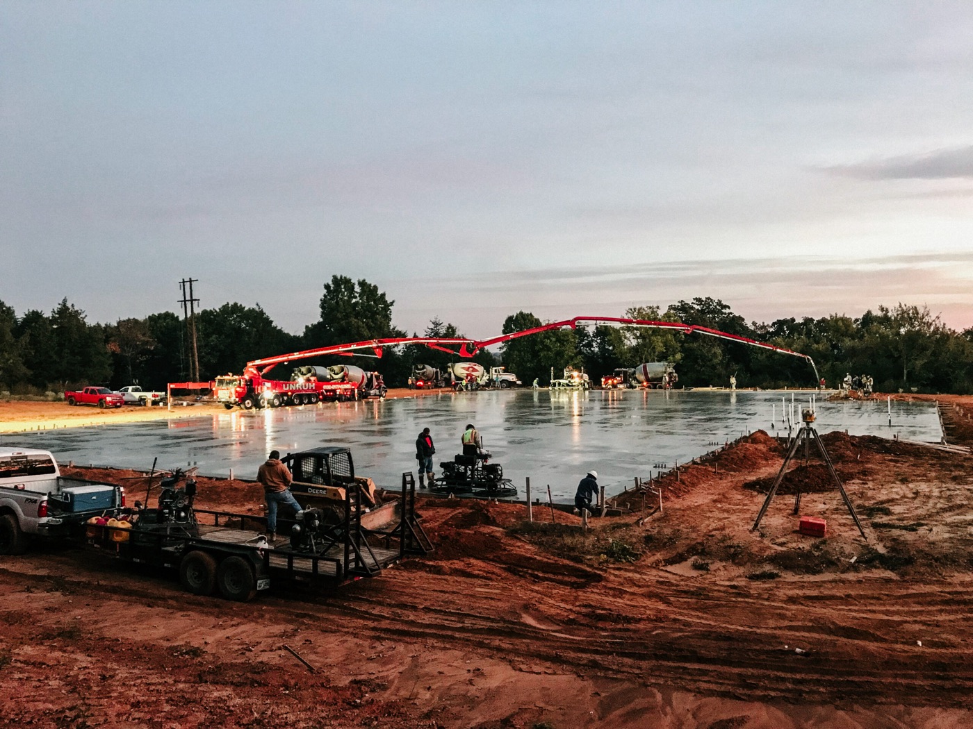 Large commercial concrete slab pour at dusk